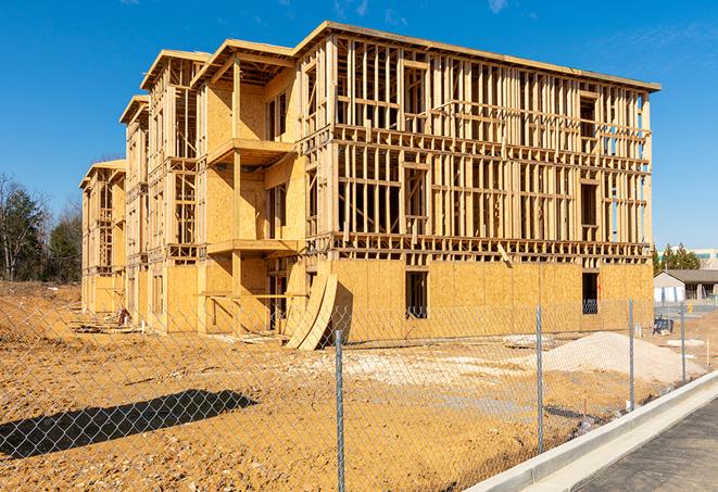 a temporary chain link fence in front of a building under construction, ensuring public safety in Eddy TX